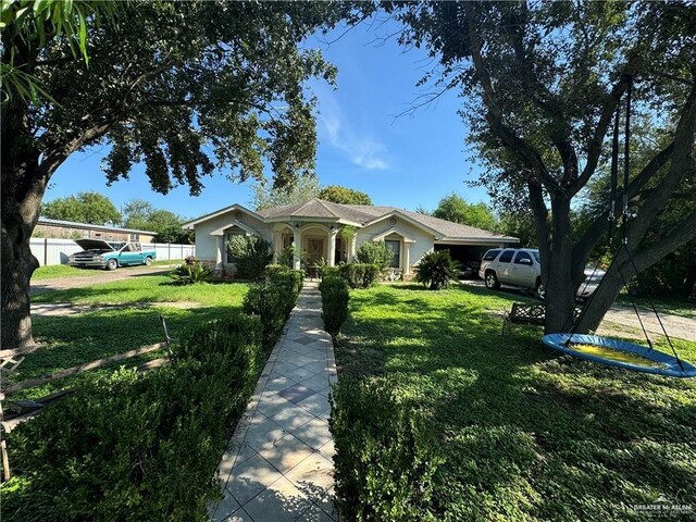 single story home featuring a front yard