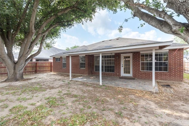 2109 E 28th St, Mission, TX 78574 - rear view of property featuring fence, a patio, and brick siding