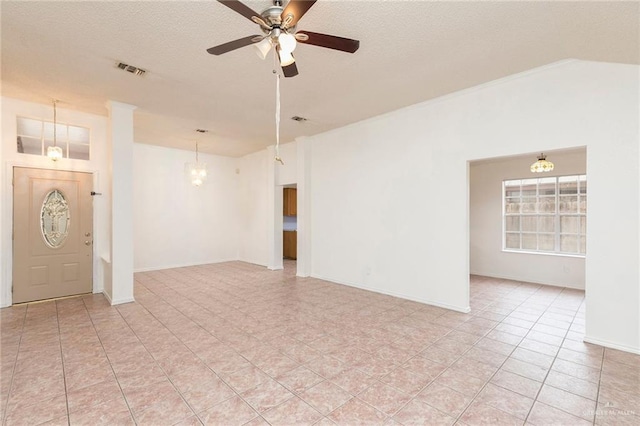 2109 E 28th St, Mission, TX 78574 - spare room featuring a textured ceiling, ceiling fan with notable chandelier, baseboards, and visible vents
