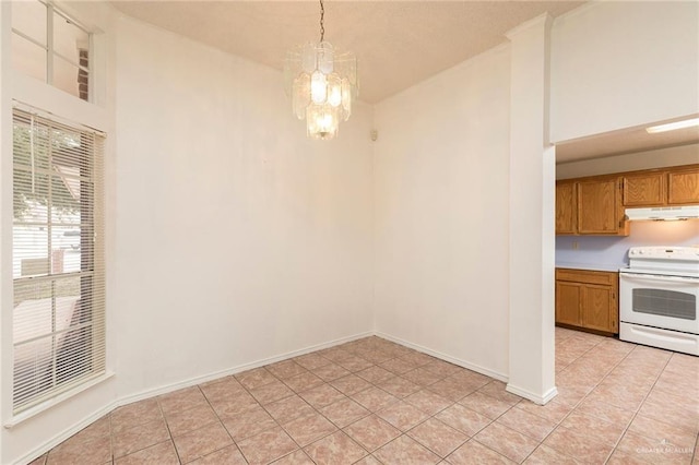 2109 E 28th St, Mission, TX 78574 - unfurnished dining area featuring an inviting chandelier, light tile patterned flooring, and baseboards