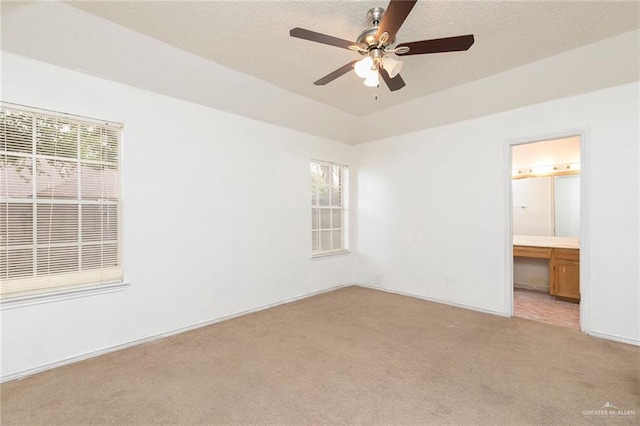 2109 E 28th St, Mission, TX 78574 - unfurnished bedroom with light colored carpet, multiple windows, connected bathroom, and baseboards