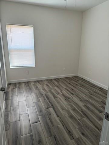 spare room featuring dark hardwood / wood-style floors and ceiling fan