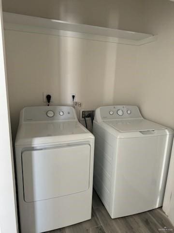 washroom featuring washer and clothes dryer and hardwood / wood-style flooring