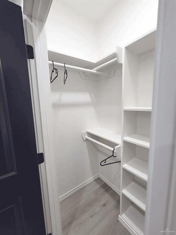 spacious closet featuring light hardwood / wood-style floors