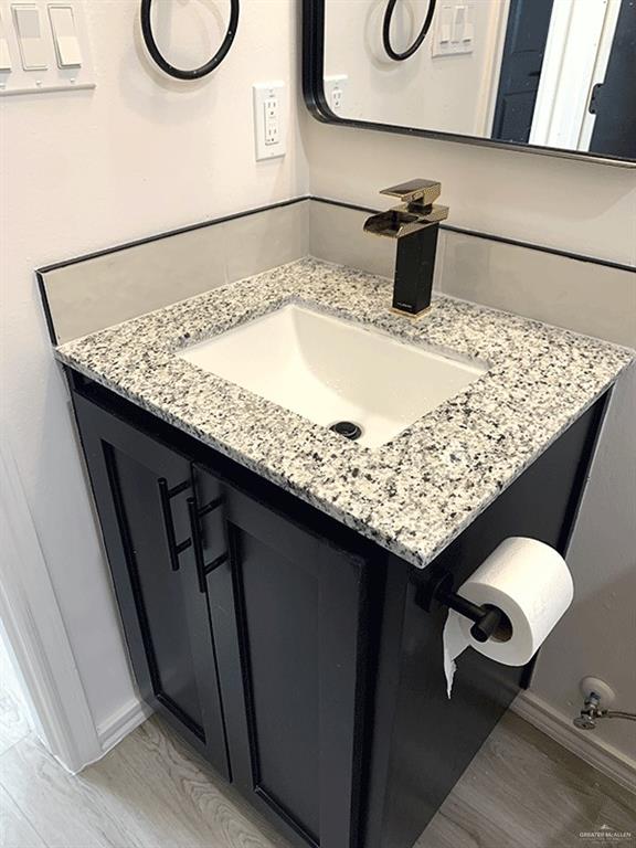 bathroom featuring vanity and wood-type flooring