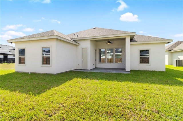 rear view of house with a lawn, a patio area, and central AC unit