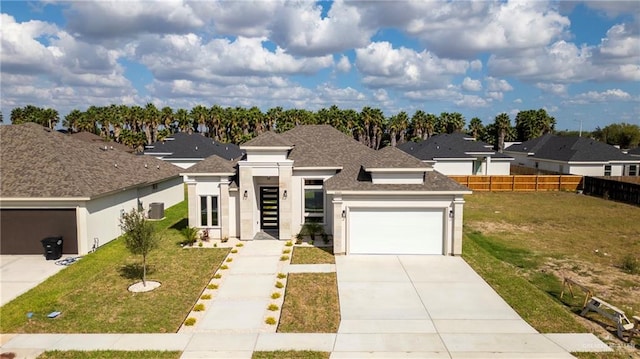 view of front of house featuring a front yard and a garage