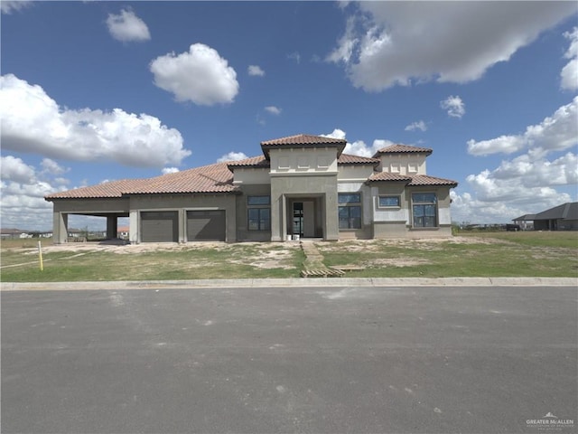 mediterranean / spanish house with a garage