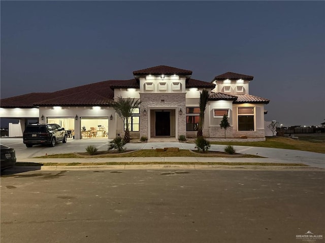 mediterranean / spanish house featuring a garage