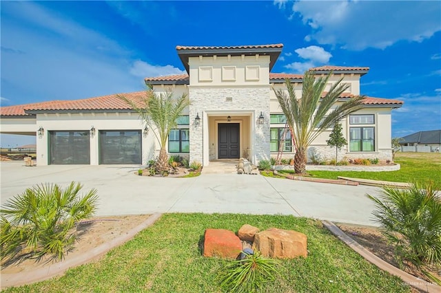 mediterranean / spanish-style home with stone siding, concrete driveway, an attached garage, and stucco siding