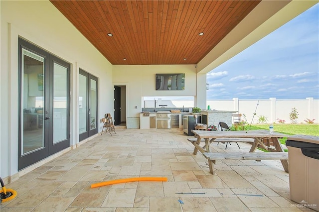 view of patio with outdoor dining area, area for grilling, and fence