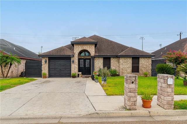 view of front of house with a garage and a front yard