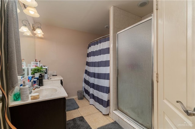 bathroom featuring a tile shower, tile patterned flooring, vanity, and an inviting chandelier