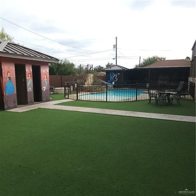 view of swimming pool with a lawn and a water slide