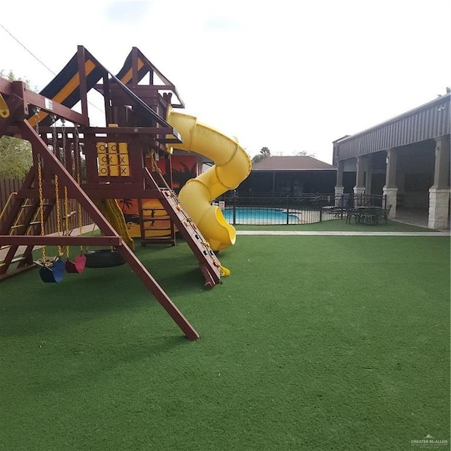 view of jungle gym featuring a lawn and a patio