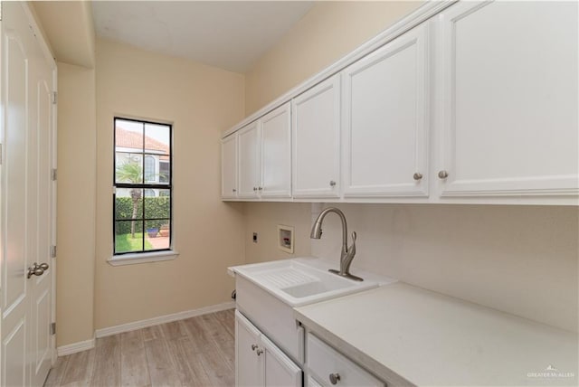 washroom featuring cabinets, hookup for a washing machine, electric dryer hookup, sink, and light hardwood / wood-style floors