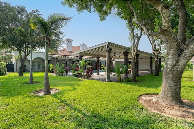 view of yard with a pergola, ceiling fan, and a patio area