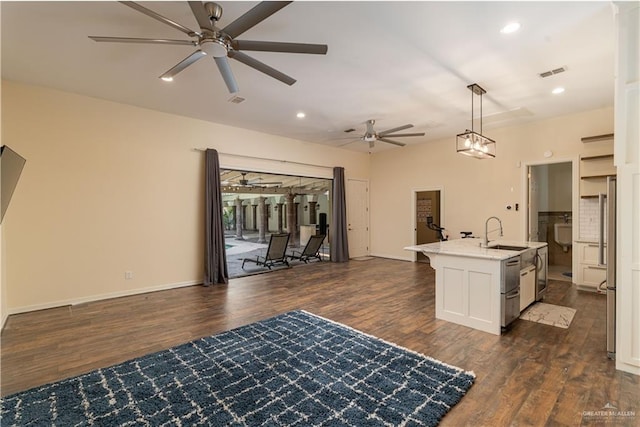 interior space featuring dark hardwood / wood-style floors, ceiling fan, and sink