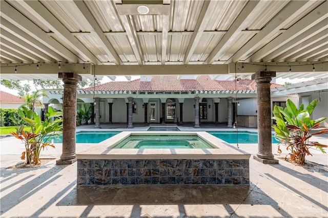 view of pool with a patio area and an in ground hot tub