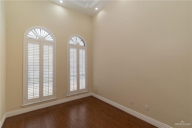 empty room with dark hardwood / wood-style flooring