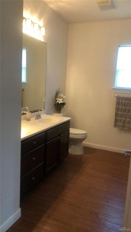 bathroom featuring hardwood / wood-style floors, vanity, and toilet