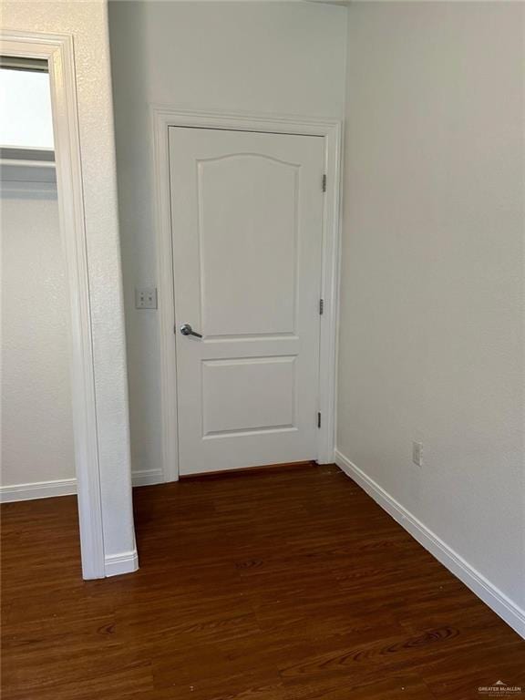 corridor with dark wood-type flooring