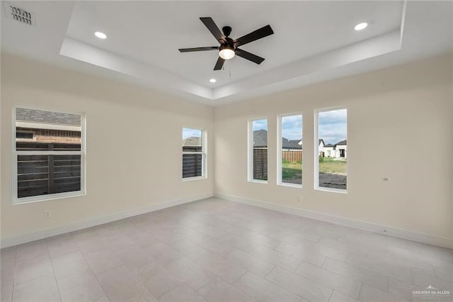 4012 Burr Dr, Edinburg, TX 78542 - spare room with a raised ceiling, recessed lighting, and a ceiling fan