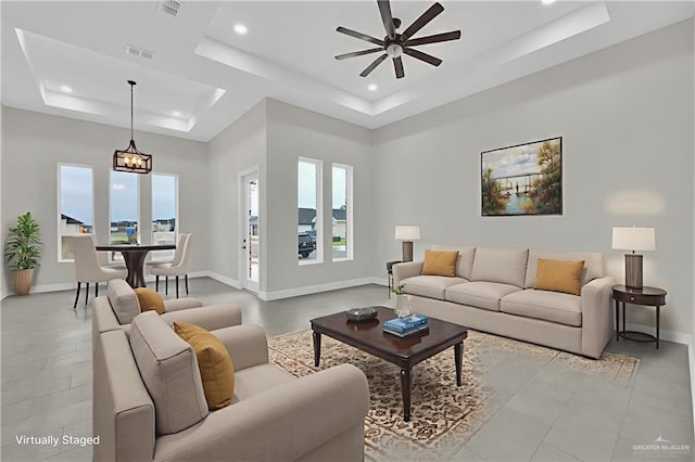4012 Burr Dr, Edinburg, TX 78542 - living room with a tray ceiling, plenty of natural light, a ceiling fan, recessed lighting, and a chandelier