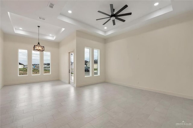 4012 Burr Dr, Edinburg, TX 78542 - empty room featuring a tray ceiling, recessed lighting, ceiling fan, and a chandelier