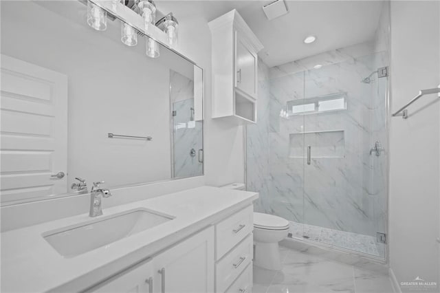 bathroom featuring marble finish floor, a marble finish shower, toilet, recessed lighting, and vanity
