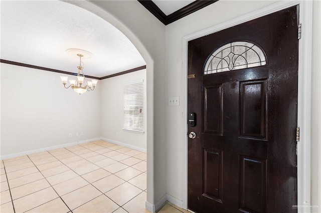 8907 Other, San Antonio, TX 78242 - entrance foyer with arched walkways, crown molding, a chandelier, baseboards, and light tile patterned floors