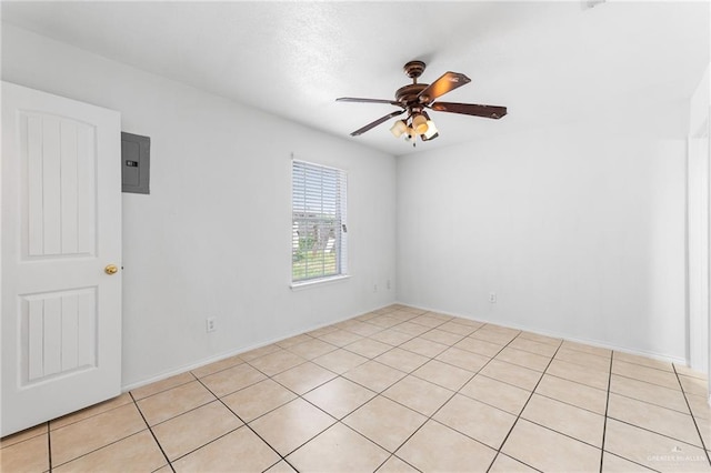 8907 Other, San Antonio, TX 78242 - empty room featuring electric panel, a ceiling fan, and light tile patterned floors
