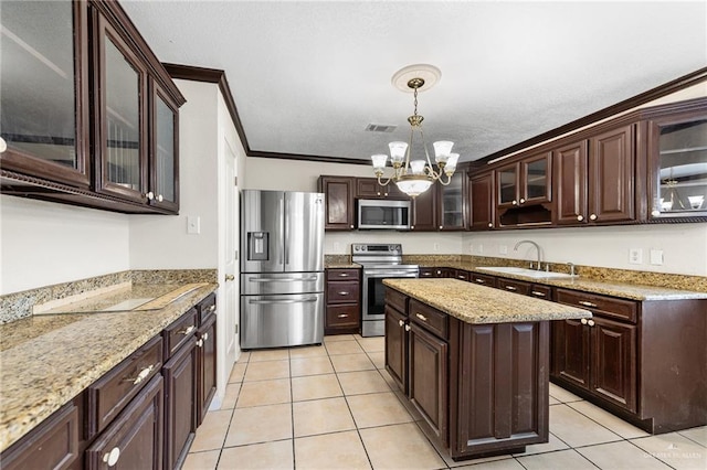 8907 Other, San Antonio, TX 78242 - kitchen with stainless steel appliances, a sink, a chandelier, dark brown cabinets, and ornamental molding