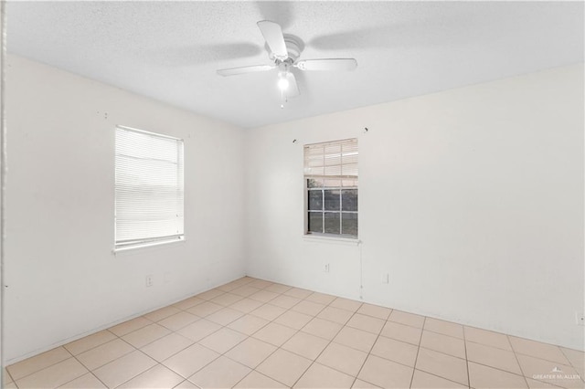 spare room featuring ceiling fan and a textured ceiling