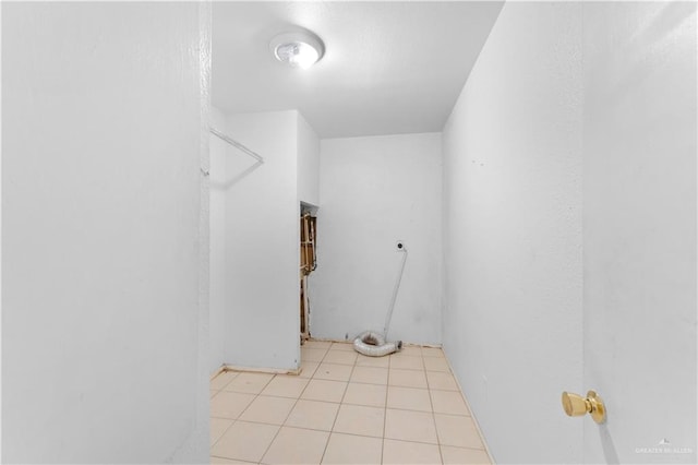 clothes washing area featuring light tile patterned floors