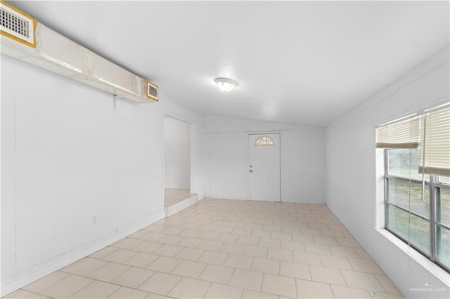 empty room with vaulted ceiling
