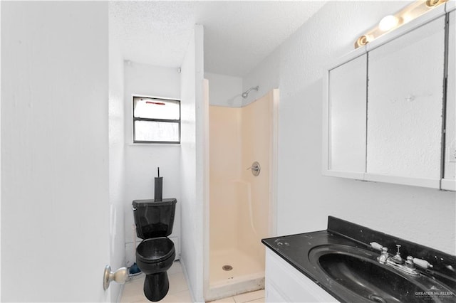 bathroom featuring walk in shower, tile patterned floors, vanity, and a textured ceiling