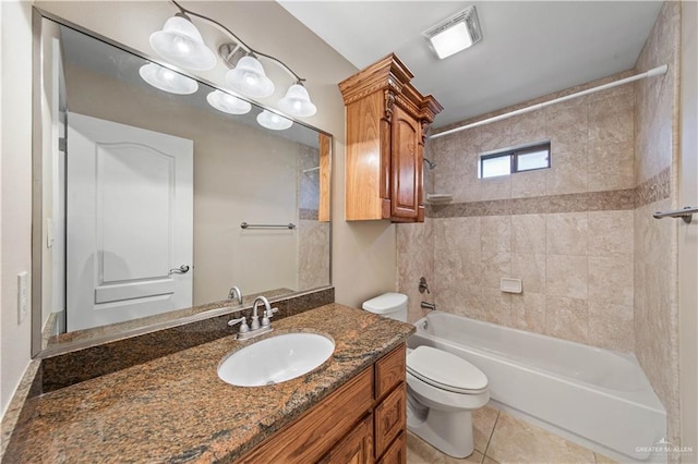 full bathroom with vanity, tile patterned floors, toilet, and tiled shower / bath