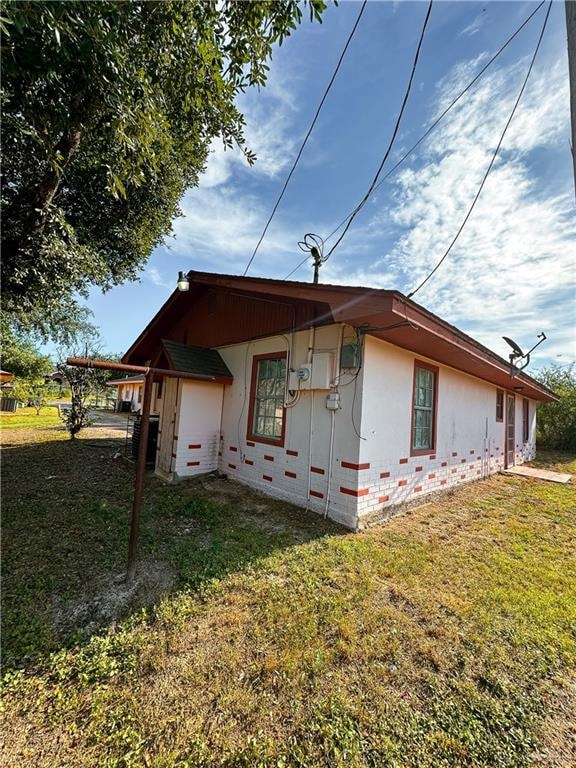 rear view of property featuring a yard