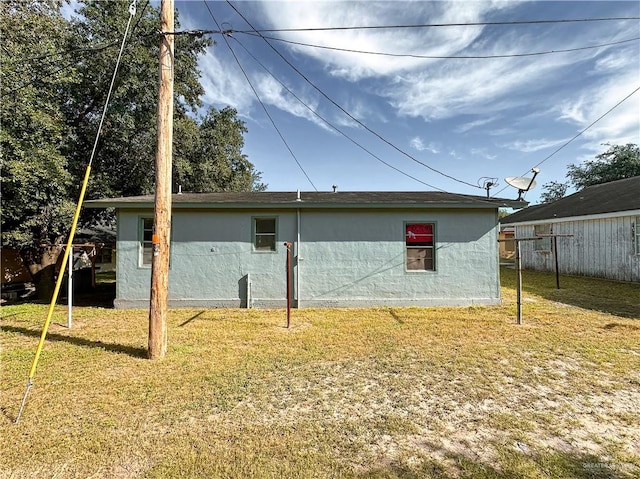 back of property featuring a yard