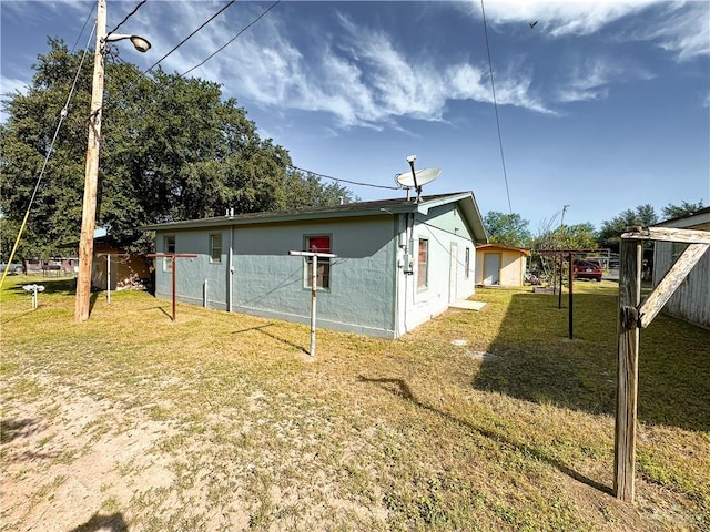 view of side of home featuring a yard