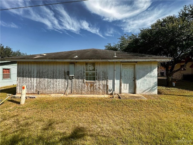 rear view of house with a lawn