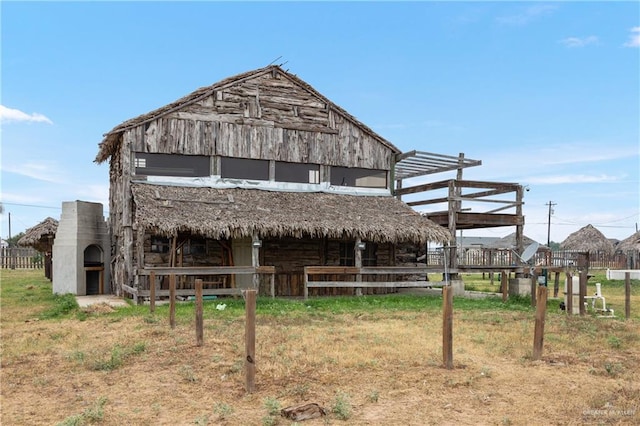 rear view of house with an outdoor structure