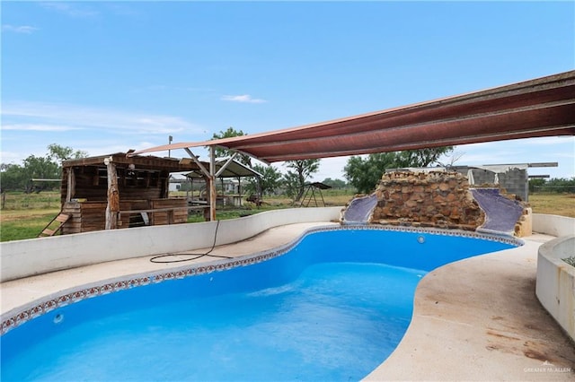 view of pool with a gazebo, an outdoor bar, and a water slide