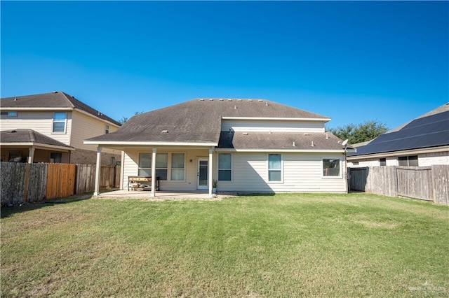 rear view of house with a lawn and a patio area