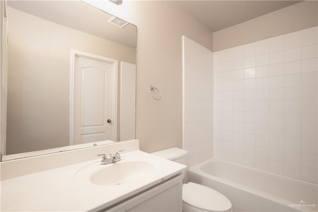 full bathroom featuring washtub / shower combination, vanity, and toilet