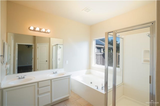 bathroom with vanity, tile patterned flooring, and plus walk in shower