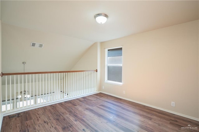 additional living space featuring hardwood / wood-style flooring and vaulted ceiling