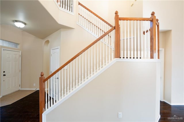 stairway with hardwood / wood-style flooring