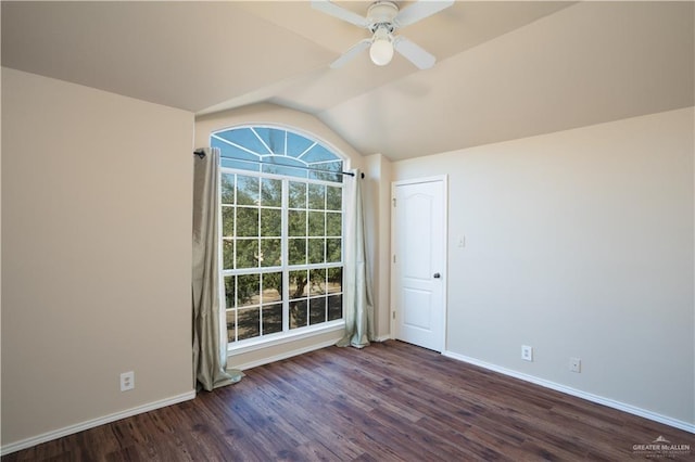 unfurnished room featuring dark hardwood / wood-style flooring, vaulted ceiling, and ceiling fan